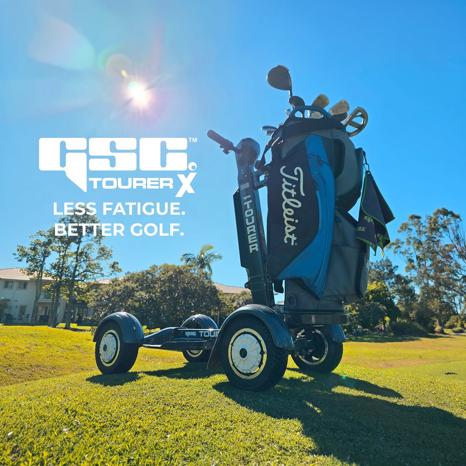 Golf cart with Titleist Tourer X bag on a golf course with clear blue sky.
