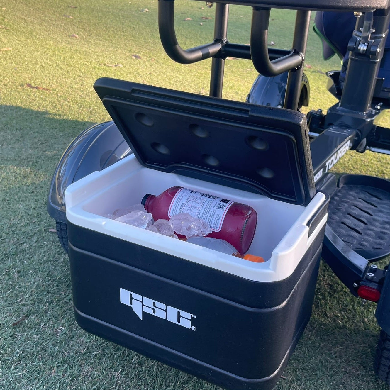 Black cooler attached to the GSC Tourer X on a grassy field